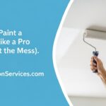 A close-up view of a professional painter's hand carefully cutting in the edge of a white ceiling with an angled brush next to a blue-taped wall, a demonstration of proper ceiling painting technique from the experts at Renovationservices.com, ensuring a clean line and a professional result for NYC homes.